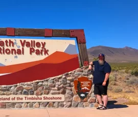 WanderBeard Standing At Death Valley National Park Sign At Nevada Entrance On Highway 374 WanderBeard Standing At Death Valley National Park Sign At Nevada Entrance On Highway 374